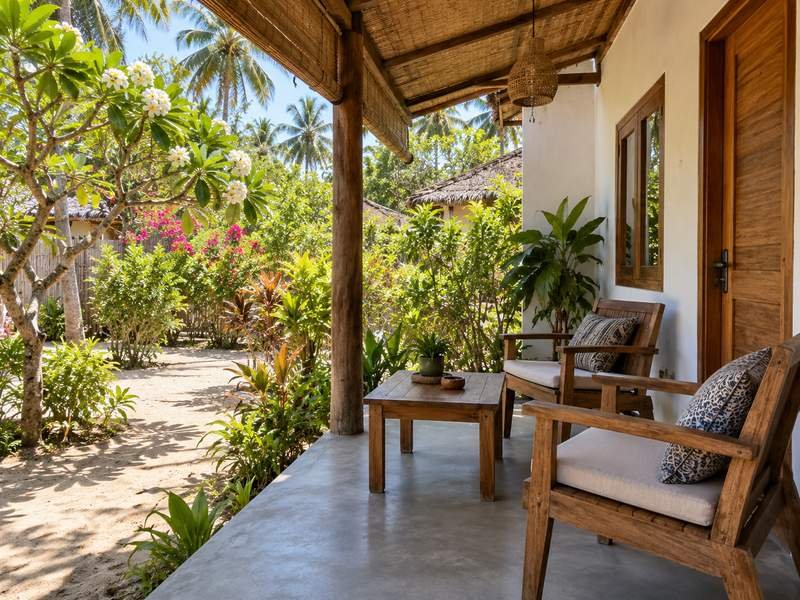 Shaded homestay terrace with chairs and a small garden on Gili Air