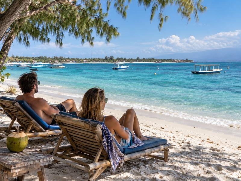 Visitors relaxing on the beach at Gili Trawangan